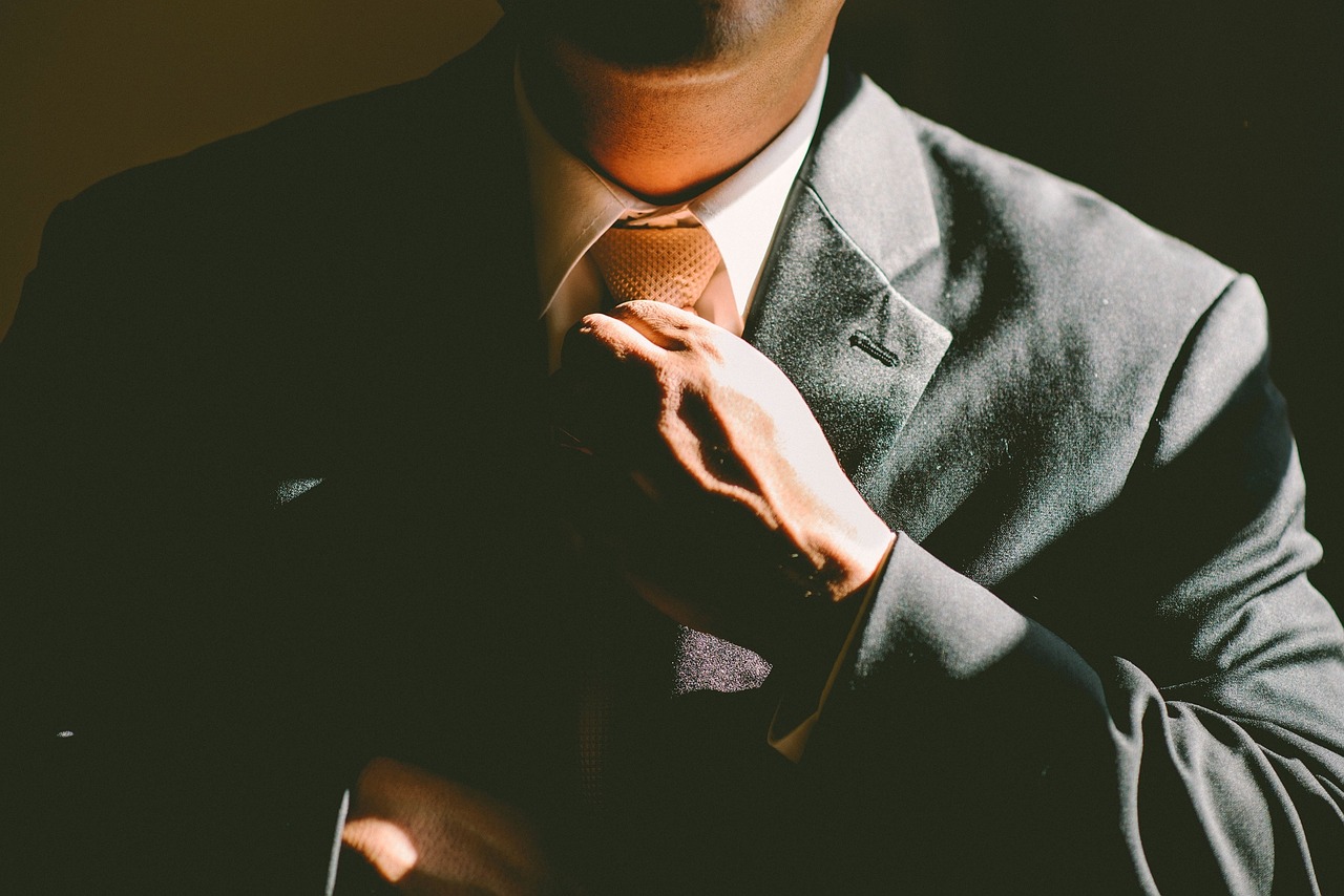 A person adjusting their tie