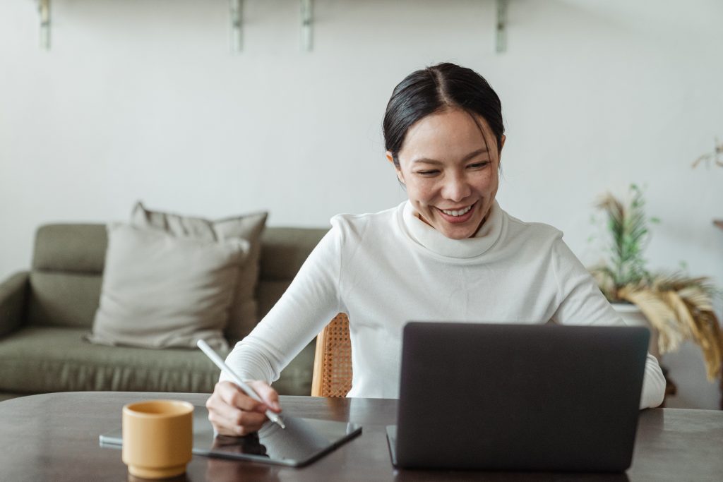 A person seated at a desk participating in online training.