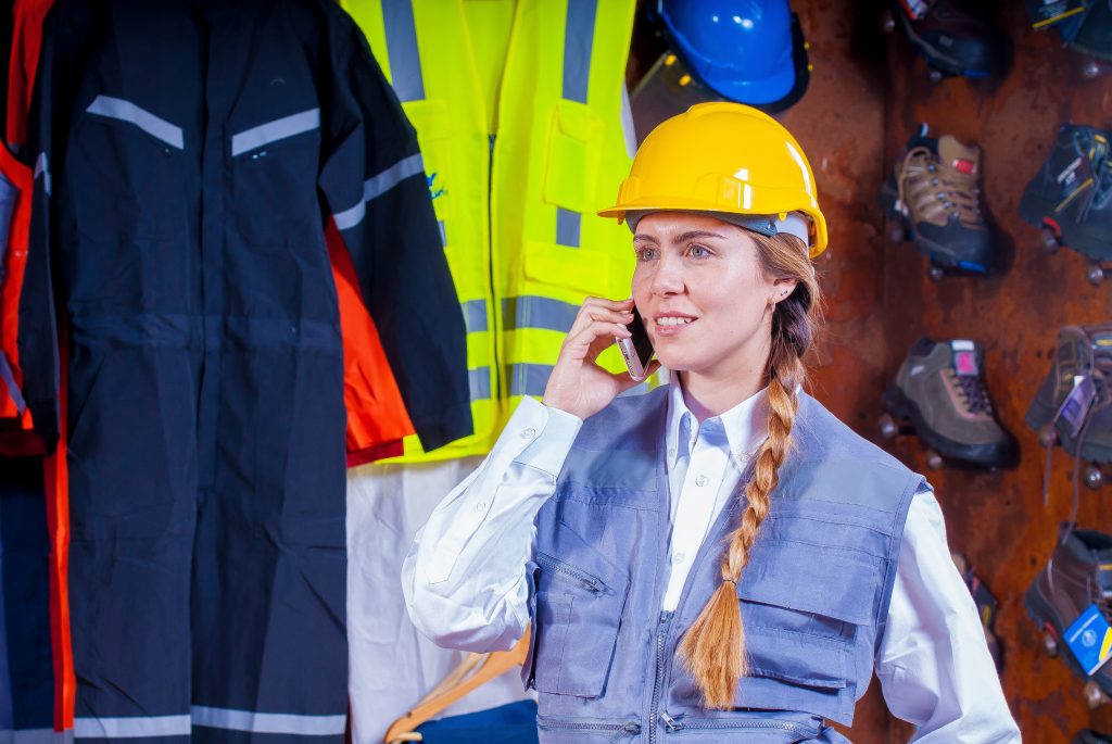 A supervisor in high visibility gear on the telephone.