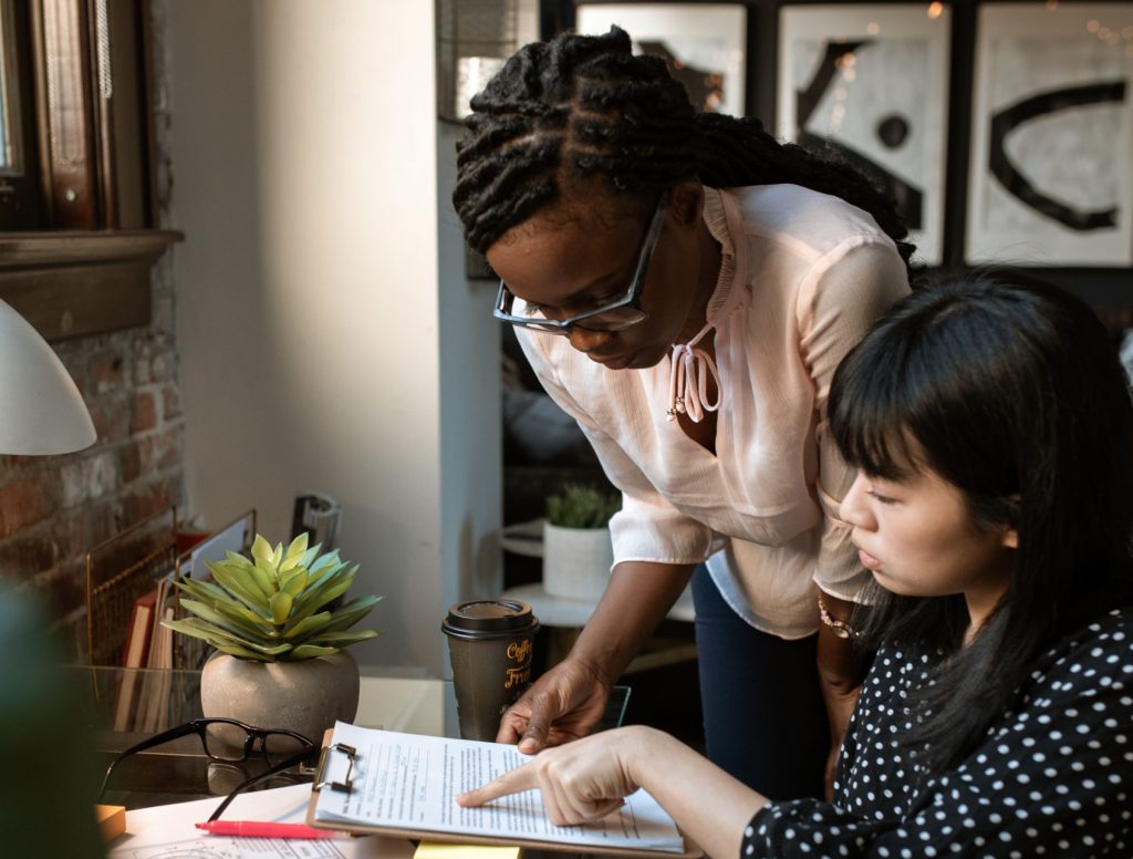 Two people planning a task list for a project.